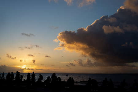 Salvador, Bahia, Brazil - June 06, 2021: Several people enjoying the sunset at Ponto do Humaita in Salvador.の写真素材