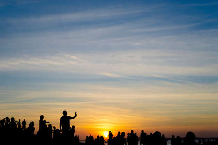 Salvador, Bahia, Brazil - June 12, 2021: Silhouette of people enjoying the wonderful colorful sunset of Farol da Barra in Salvador, Bahia.のeditorial素材