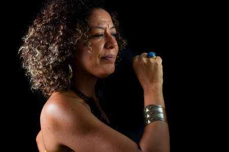 Afro-Brazilian model portrait in studio with black background. Concept of awareness, maturity and...