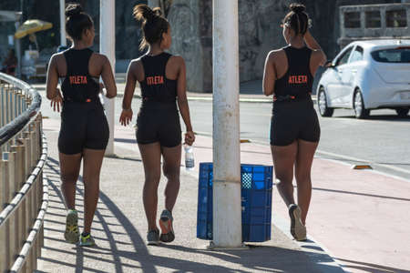 Salvador, Bahia, Brazil - January 08, 2020: Three young women walking along the shore of Ondina beach in Salvador, Bahia, BRazil.のeditorial素材
