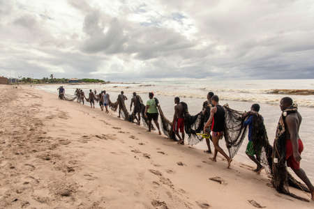 Salvador, Bahia, Brazil - January 11, 2019: Fishermen taking the big net to the colony.のeditorial素材