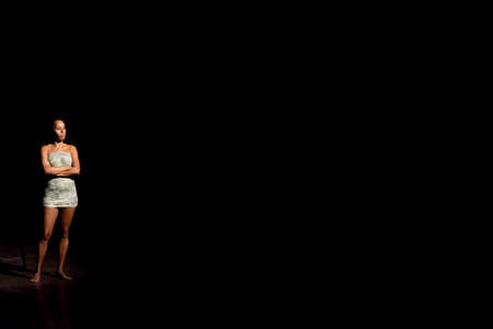 Actress standing at the theater playing a character in a show. Black background. Salvador Bahia...