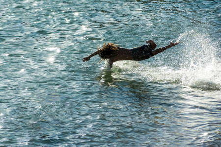 Man entering and jumping into the sea from the beach of Ondina with speed and skill. Salvador Bahia Brazil.のeditorial素材