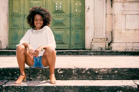 Portrait of a model against green color door. Salvador Bahia Brazil.の写真素材
