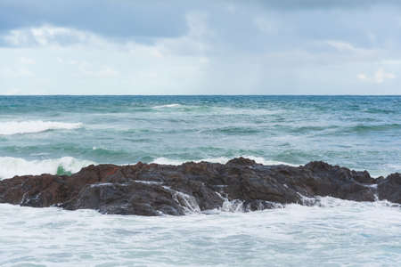 Sea waves from Praia do Rio Vermelho breaking on the clear sands. Salvador, Bahia, Brazil.の写真素材