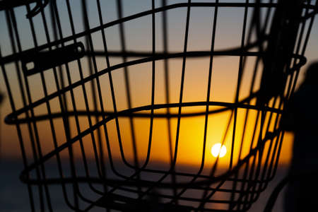 Iron basket against the yellow sunset. City of Salvador, Bahia, Brazil.の写真素材