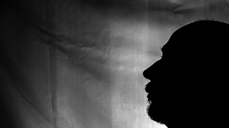 Black and white portrait in Silhouette of a man against white background. Salvador, Bahia, Brazil.の写真素材