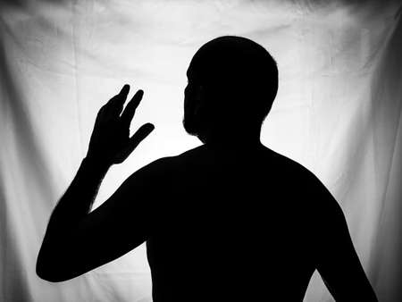 Black and white portrait in Silhouette of a man against white background. Salvador, Bahia, Brazil.の写真素材