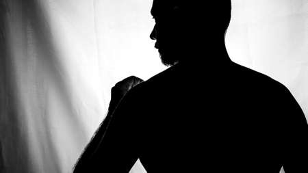 Black and white portrait in Silhouette of a man against white background. Salvador, Bahia, Brazil.の写真素材
