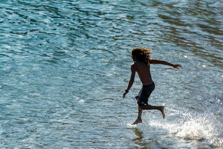 Salvador, Bahia, Brazil - January 08, 2020: Man entering and jumping into the sea from the beach of Ondina with speed and skill. Salvador Bahia Brazil.のeditorial素材