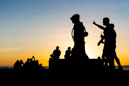 Salvador, Bahia, Brazil - November 12, 2021: Silhouette of group of people enjoying the sunset. Salvador, Bahia, Brazil.のeditorial素材