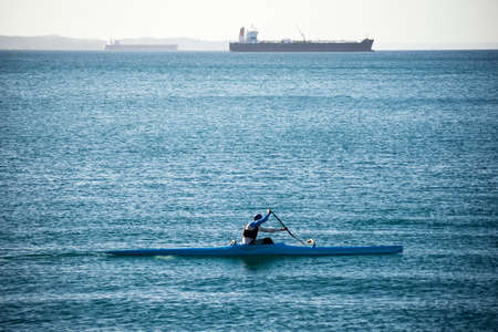 Salvador, Bahia, Brazil - November 12, 2021: Person sailing on a kayak in the sea under strong sun. Salvador, Bahia, Brazil.のeditorial素材