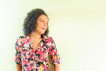 Portrait of a woman against light green background. Salvador, Bahia, Brazil.