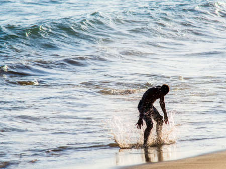 Salvador, Bahia, Brazil - January 05, 2019: Man doing marbalism in the sands of Paciencia beach, in Rio Vermelho. Salvador Bahia Brazil.のeditorial素材