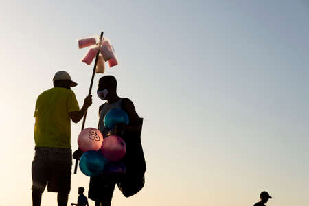 Salvador, Bahia, Brazil - July 29, 2021: Silhouette of group of people against the sunset. Salvador, Bahia, Brazil.のeditorial素材