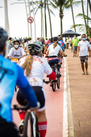 Salvador, Bahia, Brazil - August 15, 2021: Several cyclists on the Farol da Barra bike path in Salvador, Bahia, Brazil.のeditorial素材
