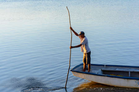 Cachoeira, Bahia, Brazil - November 29, 2014: Fisherman sailing with his canoe on the grand...