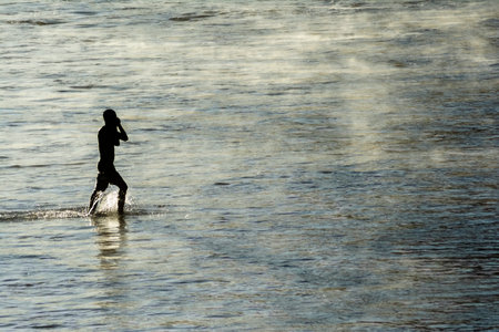 Salvador, Bahia, Brazil - January 08, 2020: Man slowly coming out of the sea from the beach of Ondina after bathing. Salvador Bahia Brazil.のeditorial素材