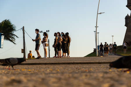 Salvador, Bahia, Brazil - July 29, 2021: Silhouette of group of people against the sunset. Salvador, Bahia, Brazil.のeditorial素材
