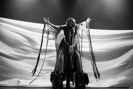actress representing a character on the stage of a theater. He makes various gestures and expressions with his body. Sesi Theater, Salvador, Bahia, Brazil.の写真素材
