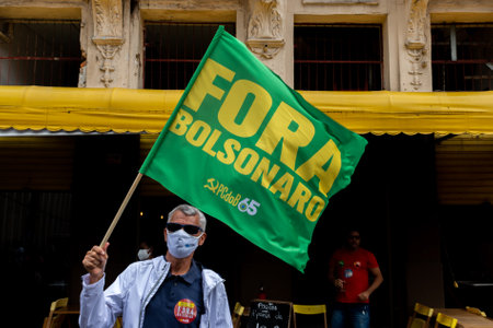 Salvador, Bahia, Brazil - July 24, 2021: People protest against the government of President Jair Bolsonaro in the city of Salvador. They use banners, posters, stickers and masks with slogans.のeditorial素材