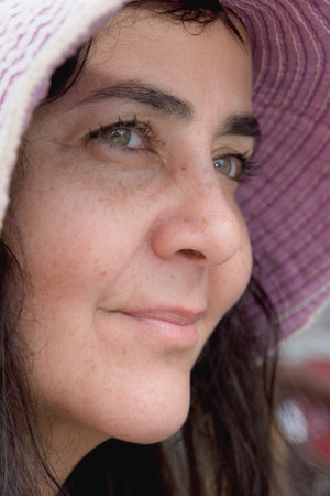 Close-up of a woman's face wearing a pink hat and looking to the side. Acupe, Bahia, Brazil.の写真素材