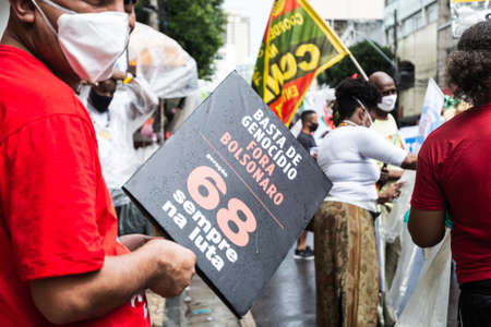 Salvador, Bahia, Brazil - July 24, 2021: People protest against the government of President Jair Bolsonaro in the city of Salvador. They use banners, posters, stickers and masks with slogans.のeditorial素材