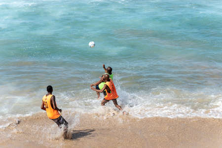 Salvador, Bahia, Brazil - August 15, 2021: People playing sand football at Farol da Barra beachfront in Salvador city, Bahia, Brazil.のeditorial素材