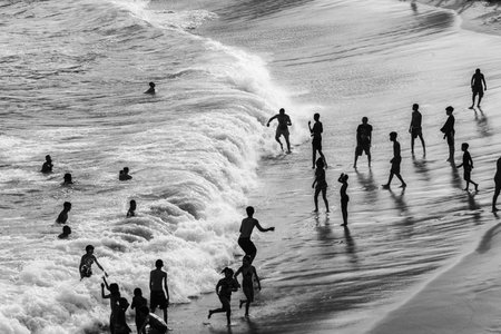 Salvador, Bahia, Brazil - August 22, 2021: Large group of people on Paciencia beach in the Rio...