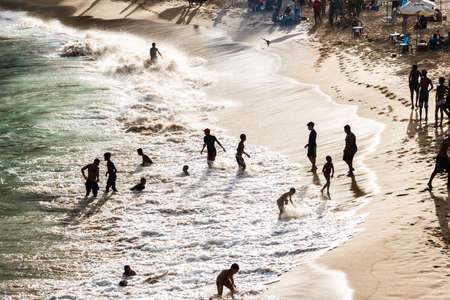 Salvador, Bahia, Brazil - August 22, 2021: Large group of people on Paciencia beach in the Rio Vermelho neighborhood of Salvador, Brazil. People having fun in the middle of the coronavirus pandemic.のeditorial素材