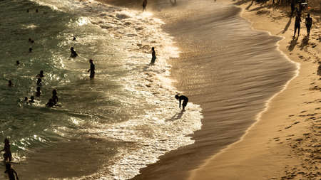 Salvador, Bahia, Brazil - August 22, 2021: Large group of people on Paciencia beach in the Rio Vermelho neighborhood of Salvador, Brazil. People having fun in the middle of the coronavirus pandemic.のeditorial素材