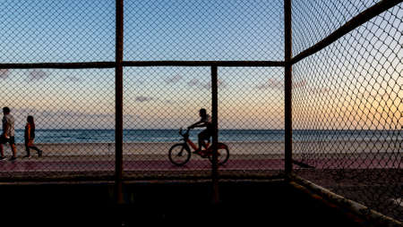 Salvador, Bahia, Brazil - September 05, 2021: People walking along the shore of Paciencia beach in Rio Vermelho neighborhood in Salvador, Brazil.のeditorial素材