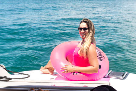 A woman on top of a boat against the sea in the background. Salvador, Bahia, Brazil.の写真素材