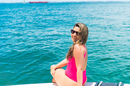 A woman on top of a boat against the sea in the background. Salvador, Bahia, Brazil.の写真素材