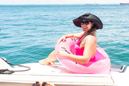 A woman on top of a boat against the sea in the background. Salvador, Bahia, Brazil.の写真素材