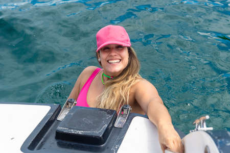 A woman on top of a boat against the sea in the background. Salvador, Bahia, Brazil.の写真素材