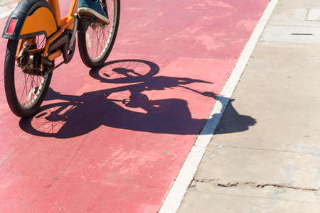 Shadow of a bicycle on the bike path in the city of Salvador, Brazil.の写真素材
