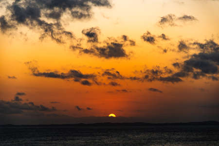 Dramatic sunset at Farol da Barra in Salvador, Bahia, Brazil.