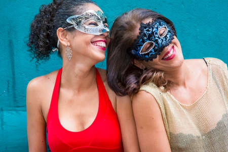 Portrait of two women wearing Carnival mask. Salvador, Bahia, Brazil.