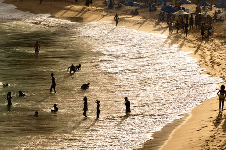 Salvador, Bahia, Brazil - August 22, 2021: Large group of people on Paciencia beach in the Rio Vermelho neighborhood of Salvador, Brazil. People having fun in the middle of the coronavirus pandemic.のeditorial素材