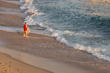 Salvador, Bahia, Brazil - September 05, 2021: Person fishing with net at Paciencia beach in Rio Vermelho neighborhood in Salvador, Brazil.のeditorial素材