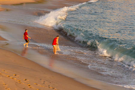 Salvador, Bahia, Brazil - September 05, 2021: Person fishing with net at Paciencia beach in Rio Vermelho neighborhood in Salvador, Brazil.のeditorial素材