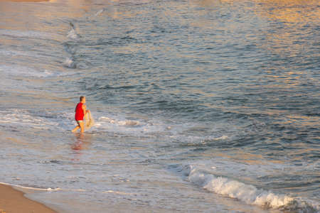 Salvador, Bahia, Brazil - September 05, 2021: Person fishing with net at Paciencia beach in Rio Vermelho neighborhood in Salvador, Brazil.のeditorial素材