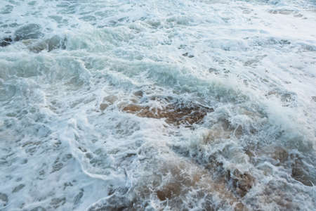 Sea waves from Praia do Rio Vermelho breaking on the clear sands. Salvador, Bahia, Brazil.の写真素材