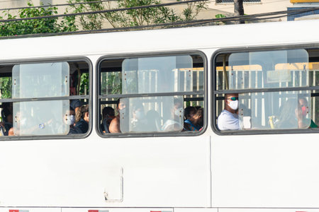 Salvador, Bahia, Brazil - October 30, 2020: People inside the bus wearing protective mask against coronavirus. Salvador, Bahia, Brazil.のeditorial素材