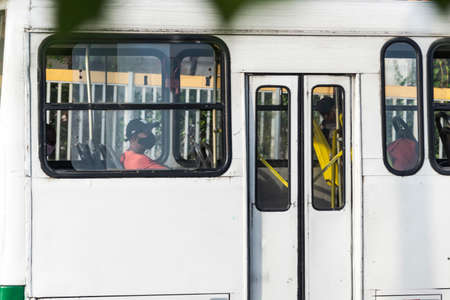 Salvador, Bahia, Brazil - October 30, 2020: People inside the bus wearing protective mask against...