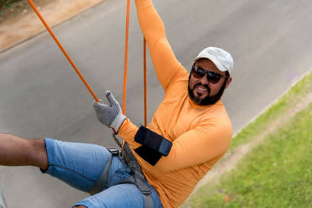Man rappelling on a pedestrian walkway. Salvador Bahia Brazil.