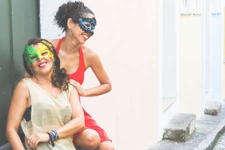 Portrait of two women wearing Venice  mask. Salvador, Bahia, Brazil.