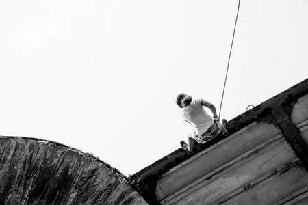 Salvador, Bahia, Brazil - September 17, 2017: Woman practicing rappel on a pedestrian walkway. Salvador Bahia Brazil.のeditorial素材