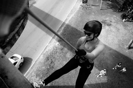 Salvador, Bahia, Brazil - September 17, 2017: Woman practicing rappel on a pedestrian walkway. Salvador Bahia Brazil.のeditorial素材